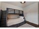 This bedroom features a bunk bed, wood floors, and unique wallpaper at 2241 Dewees Creek Dr, Mount Pleasant, SC 29466