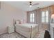 Cozy bedroom with soft pastel walls, plantation shutters, and stylish furnishings including bed, dresser, and nightstand at 2241 Dewees Creek Dr, Mount Pleasant, SC 29466