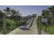 Community boardwalk with nature views and signage detailing access guidelines at 2241 Dewees Creek Dr, Mount Pleasant, SC 29466