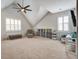 Bright bonus room featuring carpeted floors, storage options, ceiling fan, and lots of natural light at 2241 Dewees Creek Dr, Mount Pleasant, SC 29466