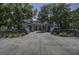 Spacious community clubhouse featuring a grand entrance and meticulously maintained landscaping along a circular driveway at 2241 Dewees Creek Dr, Mount Pleasant, SC 29466