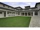 Spacious courtyard featuring lush green grass, elegant white columns, and inviting benches at 2241 Dewees Creek Dr, Mount Pleasant, SC 29466
