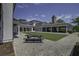 Expansive courtyard featuring a lush green lawn, a picnic table, and elegant architecture at 2241 Dewees Creek Dr, Mount Pleasant, SC 29466