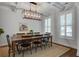 Dining room featuring stylish light fixture, large dark wooden table and chairs, and light walls at 2241 Dewees Creek Dr, Mount Pleasant, SC 29466
