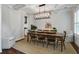 Dining room featuring stylish light fixture, large dark wooden table and chairs, and light walls at 2241 Dewees Creek Dr, Mount Pleasant, SC 29466