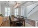 Dining room featuring stylish light fixture, large dark wooden table and chairs, and light walls at 2241 Dewees Creek Dr, Mount Pleasant, SC 29466