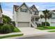 Charming two-story home with light grey siding, a front porch, and a well-maintained yard at 2241 Dewees Creek Dr, Mount Pleasant, SC 29466