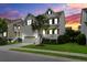 Beautiful exterior view of a home with a charming front porch, manicured lawn, and twilight sky at 2241 Dewees Creek Dr, Mount Pleasant, SC 29466