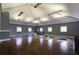Spacious fitness room with hardwood floors, wall-mounted mirrors, and modern lighting fixtures at 2241 Dewees Creek Dr, Mount Pleasant, SC 29466