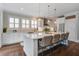 Bright kitchen with a large island, wooden floors, stainless steel appliances, and stylish pendant lighting at 2241 Dewees Creek Dr, Mount Pleasant, SC 29466