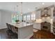 Bright kitchen with a large island, wooden floors, stainless steel appliances, and stylish pendant lighting at 2241 Dewees Creek Dr, Mount Pleasant, SC 29466