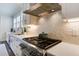Kitchen featuring stainless steel stove and oven, tile backsplash, light cabinets, and light countertops at 2241 Dewees Creek Dr, Mount Pleasant, SC 29466