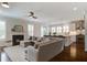 Comfortable living room featuring a fireplace that opens up to a modern kitchen area at 2241 Dewees Creek Dr, Mount Pleasant, SC 29466