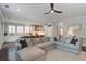 Open-concept living room with a sectional sofa, adjacent to a modern kitchen with an island at 2241 Dewees Creek Dr, Mount Pleasant, SC 29466