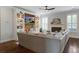 Cozy living room featuring a fireplace, built-in shelving, and a comfortable sectional sofa at 2241 Dewees Creek Dr, Mount Pleasant, SC 29466