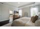 Main bedroom featuring a neutral color scheme, tray ceiling, ceiling fan, and hardwood floors at 2241 Dewees Creek Dr, Mount Pleasant, SC 29466