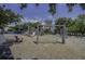 Community playground with swings, slide, and climbing structure, set in a gravel play area at 2241 Dewees Creek Dr, Mount Pleasant, SC 29466