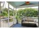 This covered porch includes comfortable patio furniture and a ceiling fan at 2241 Dewees Creek Dr, Mount Pleasant, SC 29466