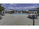 Beautiful outdoor pool with ample seating, umbrellas, and a serene atmosphere for relaxation and recreation at 2241 Dewees Creek Dr, Mount Pleasant, SC 29466