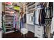 Spacious walk-in closet featuring custom shelving, drawers, ample storage, and vanity with seated dressing area at 2241 Dewees Creek Dr, Mount Pleasant, SC 29466