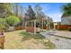 This backyard features a custom outdoor kitchen, a wooden fence, and mature trees at 236 Emerald Isle Dr, Moncks Corner, SC 29461
