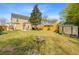 Spacious backyard featuring a fire pit, shed, and mature tree at 236 Emerald Isle Dr, Moncks Corner, SC 29461