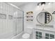Bright bathroom featuring white tiling, decorative shelves, and a vanity sink at 236 Emerald Isle Dr, Moncks Corner, SC 29461