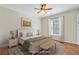 Bright bedroom with neutral decor, hardwood floors, and a window for natural light. Digitally altered at 236 Emerald Isle Dr, Moncks Corner, SC 29461