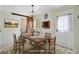 Rustic dining room with a wooden table, chandelier, barn door, and a digitally altered appearance at 236 Emerald Isle Dr, Moncks Corner, SC 29461