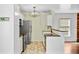A kitchen boasts white cabinets, stainless steel appliances, and tile flooring at 236 Emerald Isle Dr, Moncks Corner, SC 29461