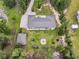 Aerial view of a secluded house with a metal roof, fire pit, garden, and lush lawn at 242 Cheyenne Rd, Summerville, SC 29483
