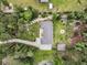 Aerial view of a single-story home showcasing the surrounding landscape, and custom outdoor firepit at 242 Cheyenne Rd, Summerville, SC 29483