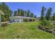 Expansive backyard featuring a covered patio, lush green grass, and well-maintained landscaping at 242 Cheyenne Rd, Summerville, SC 29483