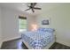 Cozy bedroom with a floral patterned bedspread, ceiling fan, and a bright window view at 242 Cheyenne Rd, Summerville, SC 29483