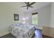 Comfortable bedroom with a blue floral bedspread, ceiling fan, and natural light at 242 Cheyenne Rd, Summerville, SC 29483