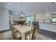 Dining area open to living room featuring hardwood floors, stylish light fixture, and neutral colors at 242 Cheyenne Rd, Summerville, SC 29483