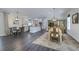 Open concept dining room and kitchen with modern lighting fixtures and wood flooring at 242 Cheyenne Rd, Summerville, SC 29483