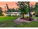 Well-maintained home showcasing lush green lawn, manicured shrubbery, and exterior lighting at 242 Cheyenne Rd, Summerville, SC 29483