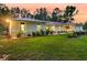 Well-maintained home showcasing lush green lawn, manicured shrubbery, and exterior lighting at 242 Cheyenne Rd, Summerville, SC 29483