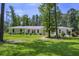 Charming home featuring a metal roof, manicured lawn and low hedges at 242 Cheyenne Rd, Summerville, SC 29483