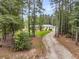 Secluded single story home nestled among towering pines and hardwood trees at 242 Cheyenne Rd, Summerville, SC 29483