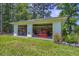 Detached garage with open doors showcasing storage and equipment at 242 Cheyenne Rd, Summerville, SC 29483