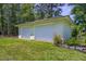 Detached two-car garage with flowering bushes, enhancing the property's appeal with extra parking or storage at 242 Cheyenne Rd, Summerville, SC 29483