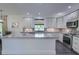 Modern kitchen boasts white cabinets, granite countertops, stainless steel appliances, and recessed lights at 242 Cheyenne Rd, Summerville, SC 29483