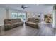 This living room features hardwood floors, recessed lights, a ceiling fan, and flows into dining and kitchen at 242 Cheyenne Rd, Summerville, SC 29483