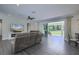 Light-filled living room with wood floors, ceiling fan, fireplace, and open access to outdoor patio at 242 Cheyenne Rd, Summerville, SC 29483