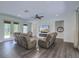 Bright living room featuring wood floors, a ceiling fan, recessed lighting, fireplace, and comfortable couches at 242 Cheyenne Rd, Summerville, SC 29483