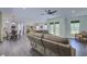 Open-concept living space with hardwood flooring, ceiling fan, and view into the kitchen and dining areas at 242 Cheyenne Rd, Summerville, SC 29483