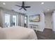Spacious main bedroom with a ceiling fan, french doors, and an oversized mounted television at 242 Cheyenne Rd, Summerville, SC 29483
