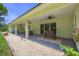 Covered patio with ceiling fans, overlooking a landscaped backyard and gravel fire pit at 242 Cheyenne Rd, Summerville, SC 29483